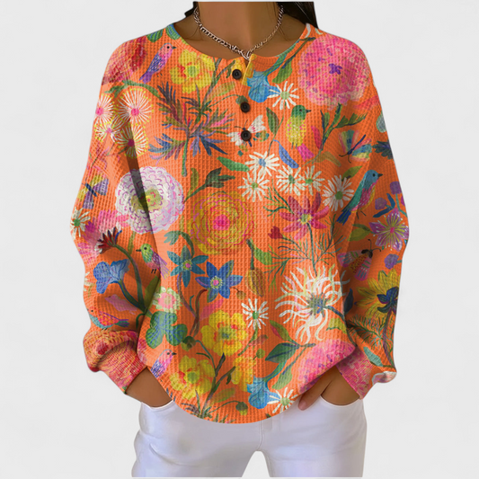 Faustine | Pull orange avec motif floral coloré